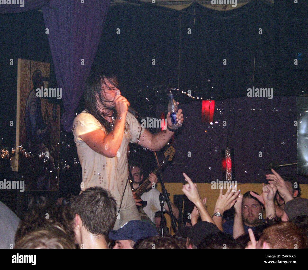 SEPTEMBER 11: Andrew WK squirts water on the crowd during his performance at the 40 Watt Club in Athens, Georgia on September 11, 2002. CREDIT: Chris McKay / MediaPunch Stock Photo