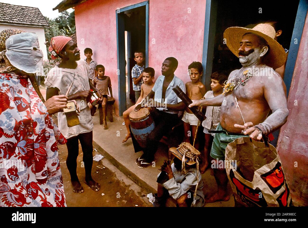 A drummer plays while costumed local villagers hold an informal carnival in rural Brazil's Bahia Provence. The event precedes Lent on the Christian calendar. Stock Photo