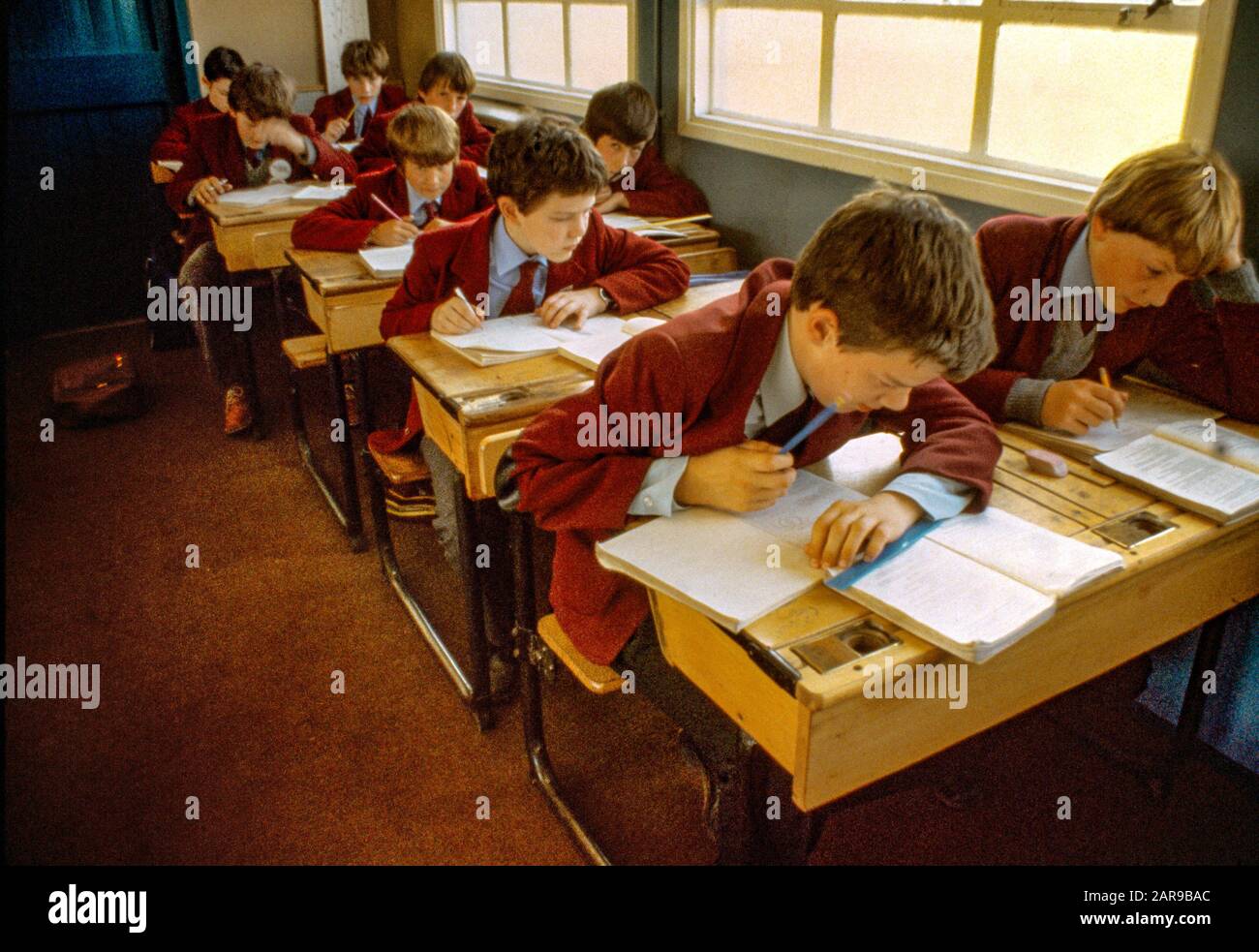 Uniformed schoolboys apply themselves in class in the village of Portree, Isle Of Skye, Inner Hebrides, Scotland. Stock Photo