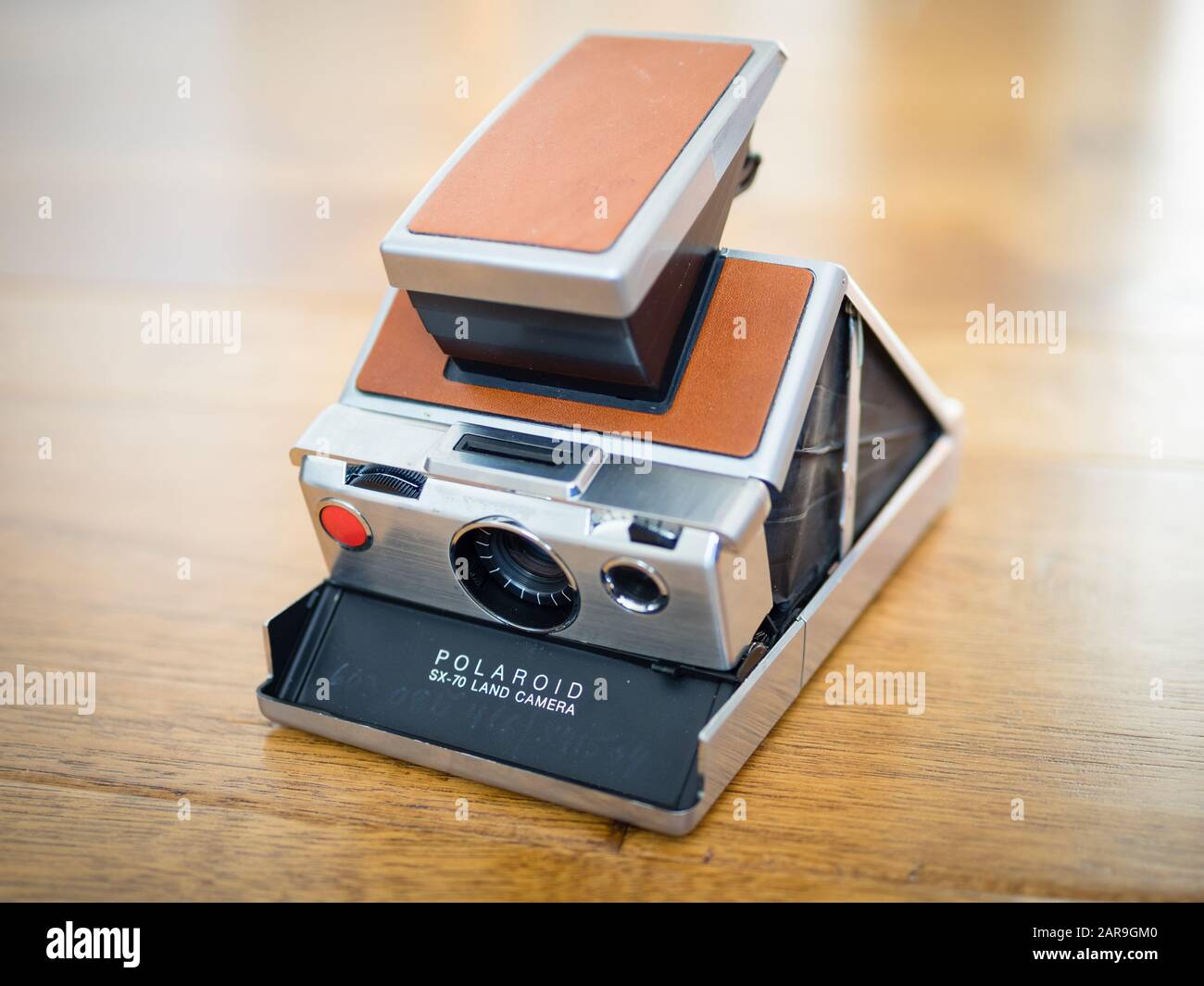 An original Polaroid SX-70 Land Camera, a folding single lens reflex instant camera which was first produced by the Polaroid Corporation in 1972. Stock Photo