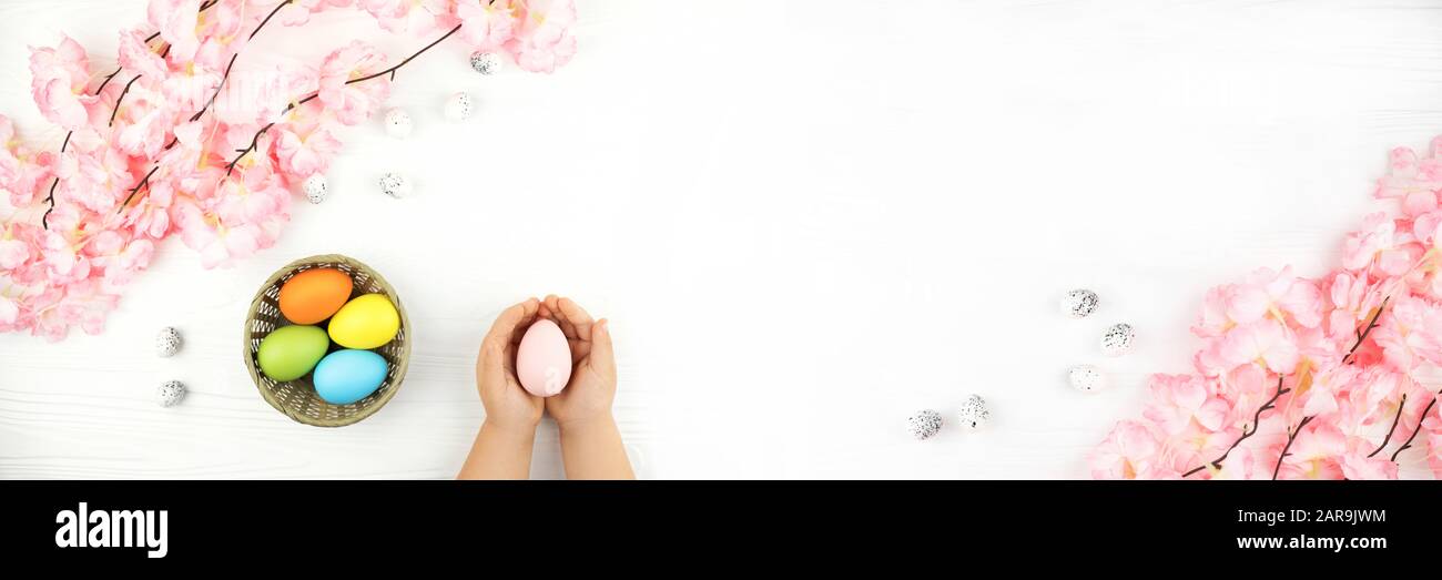 Banner made from pastel colored Easter eggs in the nest with the branch ...
