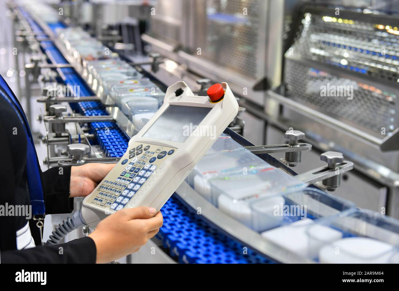 Manager check and control automation Food products boxs transfer on Automated conveyor systems in factory Stock Photo
