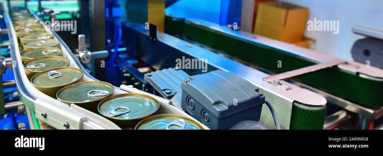 Canned food products on conveyor belt in distribution warehouse.parcels
