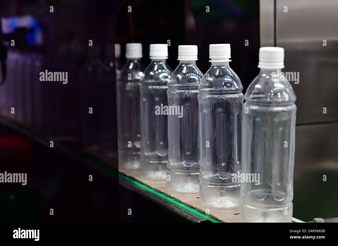 Clear plastic Bottles transfer on Automated conveyor systems industrial automation for package Stock Photo