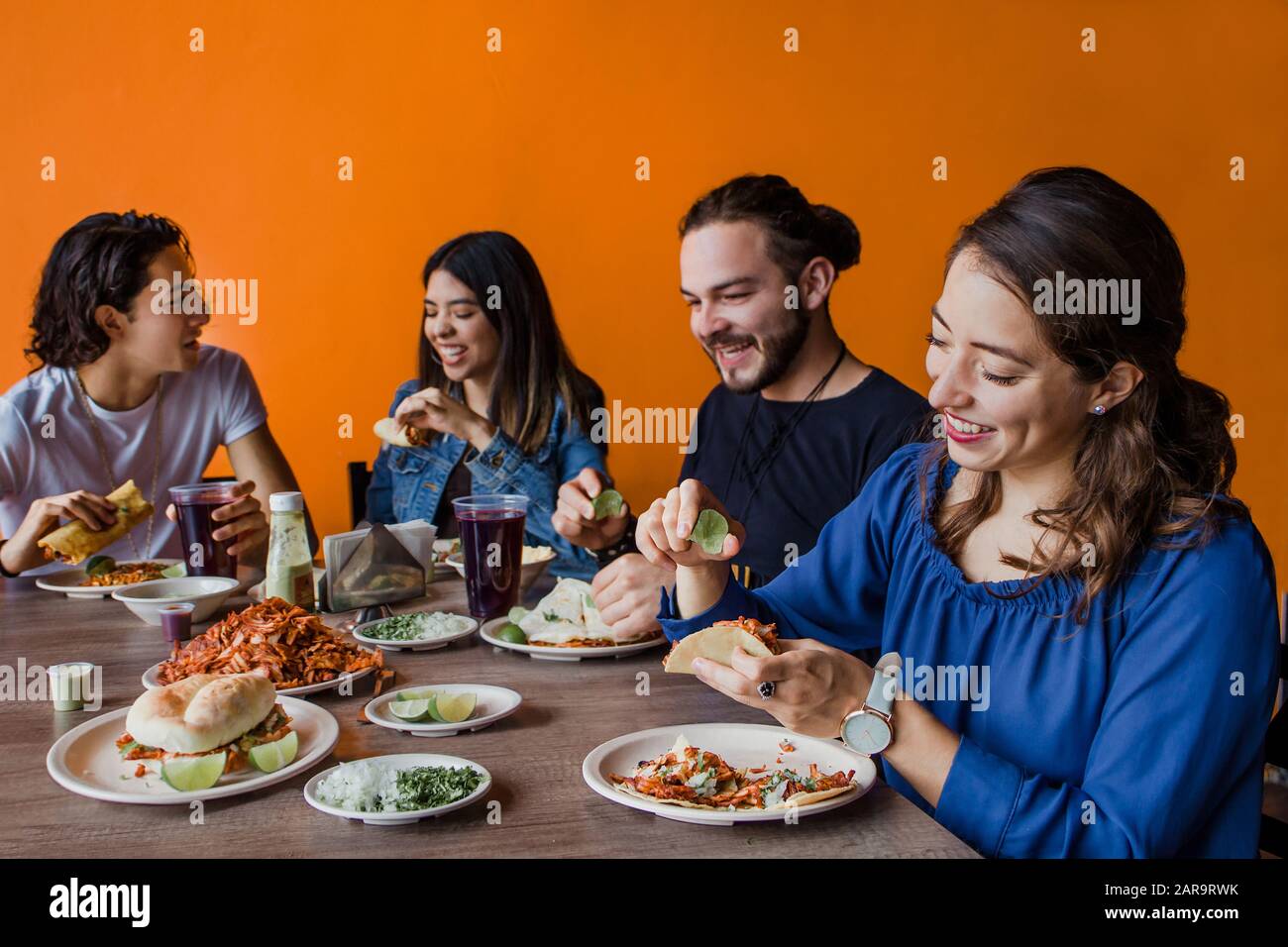 Mexican people eating Tacos al Pastor in a Taqueria in Mexico city Stock Photo