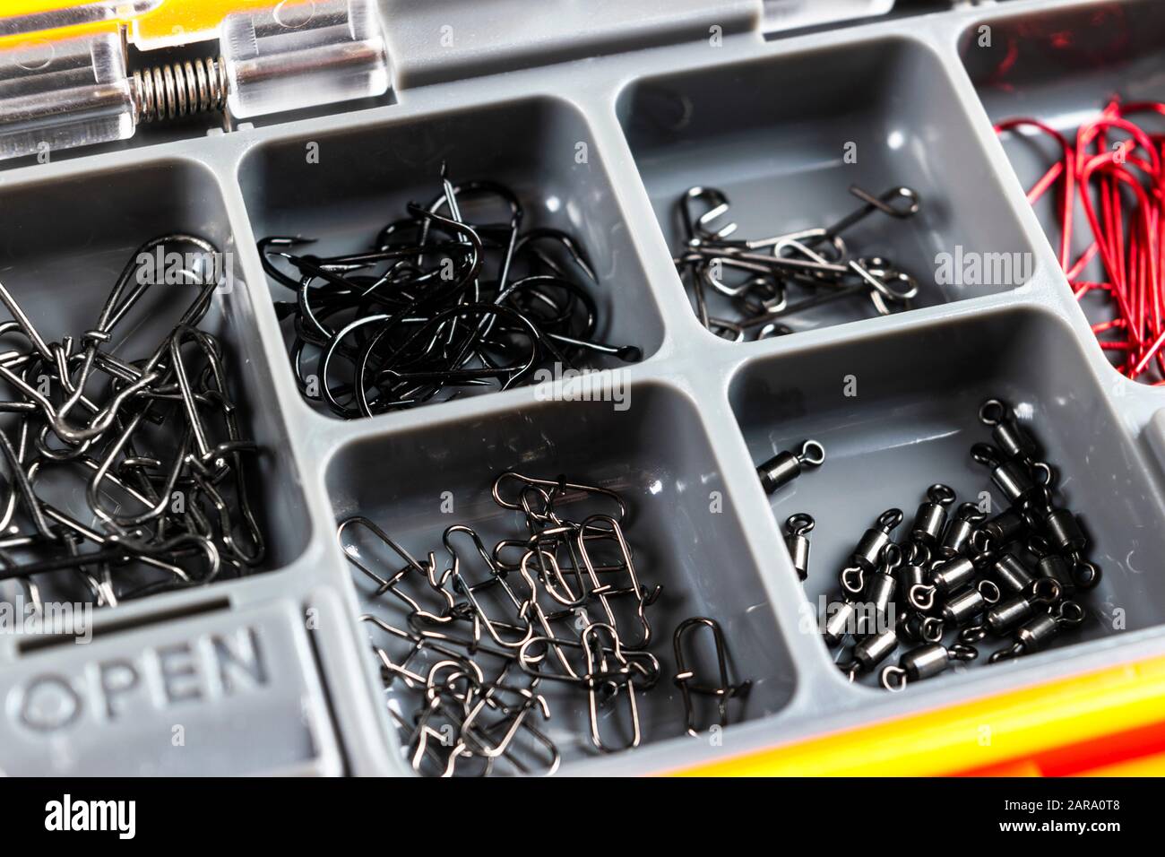Opened tackle box with fishing hooks and accessories. Fishing hooks in box  sections. Case for tackle elements. Fishing accessories background close-up  Stock Photo - Alamy