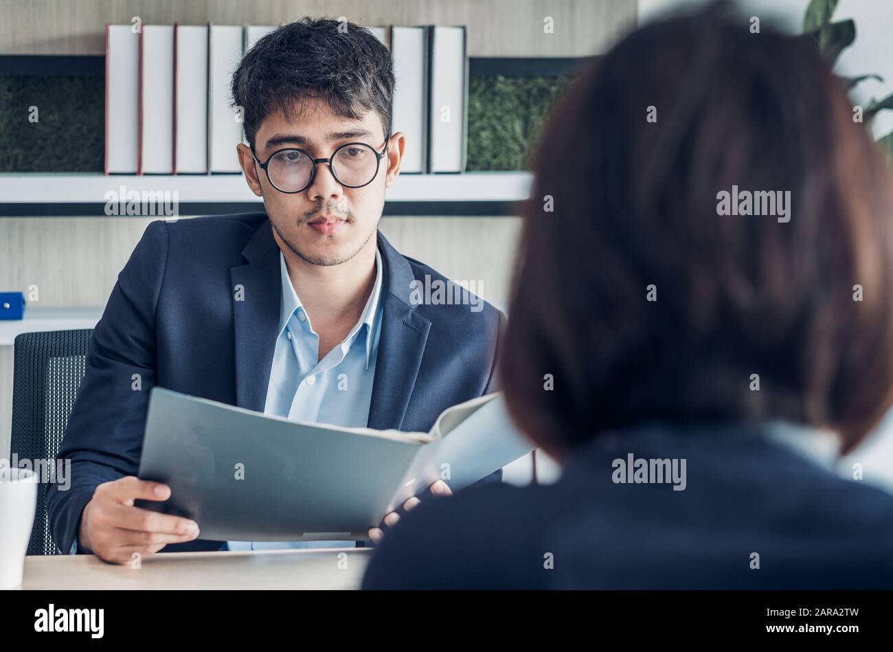 businessman interview with interviewer candidate see qualification  data that apply for job at meeting room in modern office Stock Photo