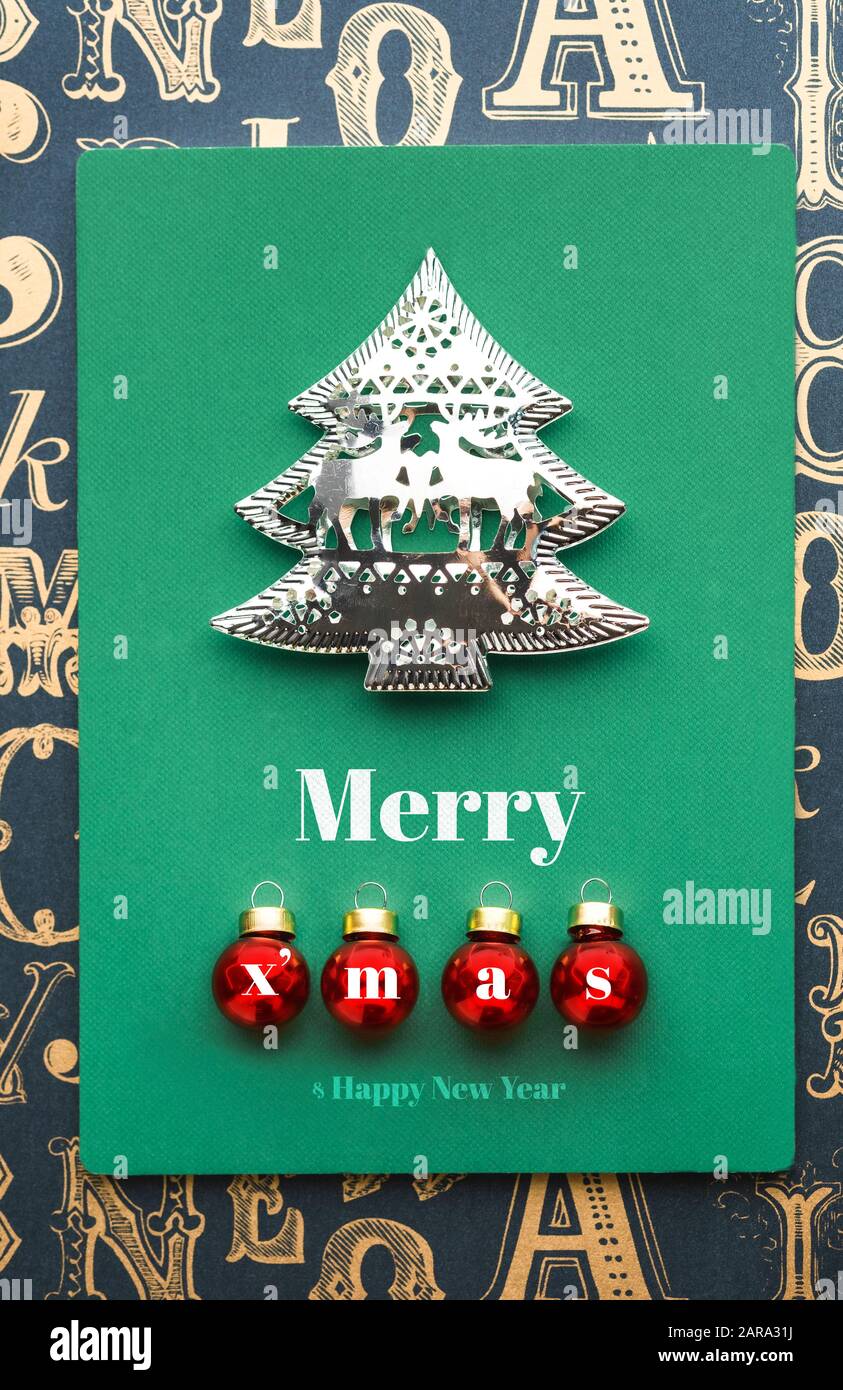 Merry Christmas and tree and xmas red ball decoration with green notebook on old type pattern background.holiday greeting card Stock Photo