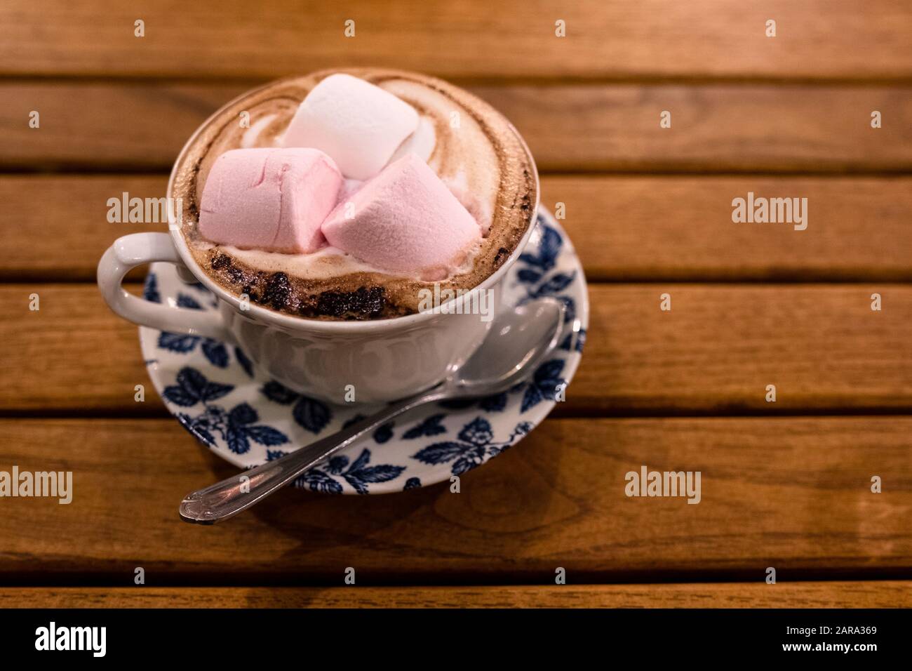 Vintage cup and saucer full of hot chocolate with marsh mellows on top. Stock Photo