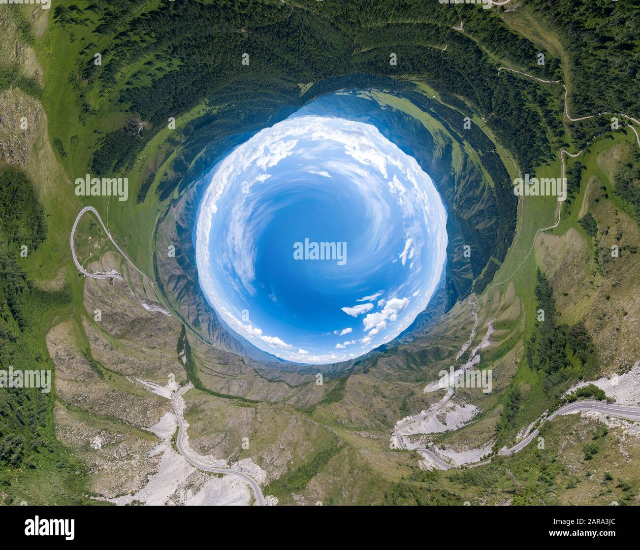 360 degree panoramic image of an abstract world turned inside out with green meadows around an 