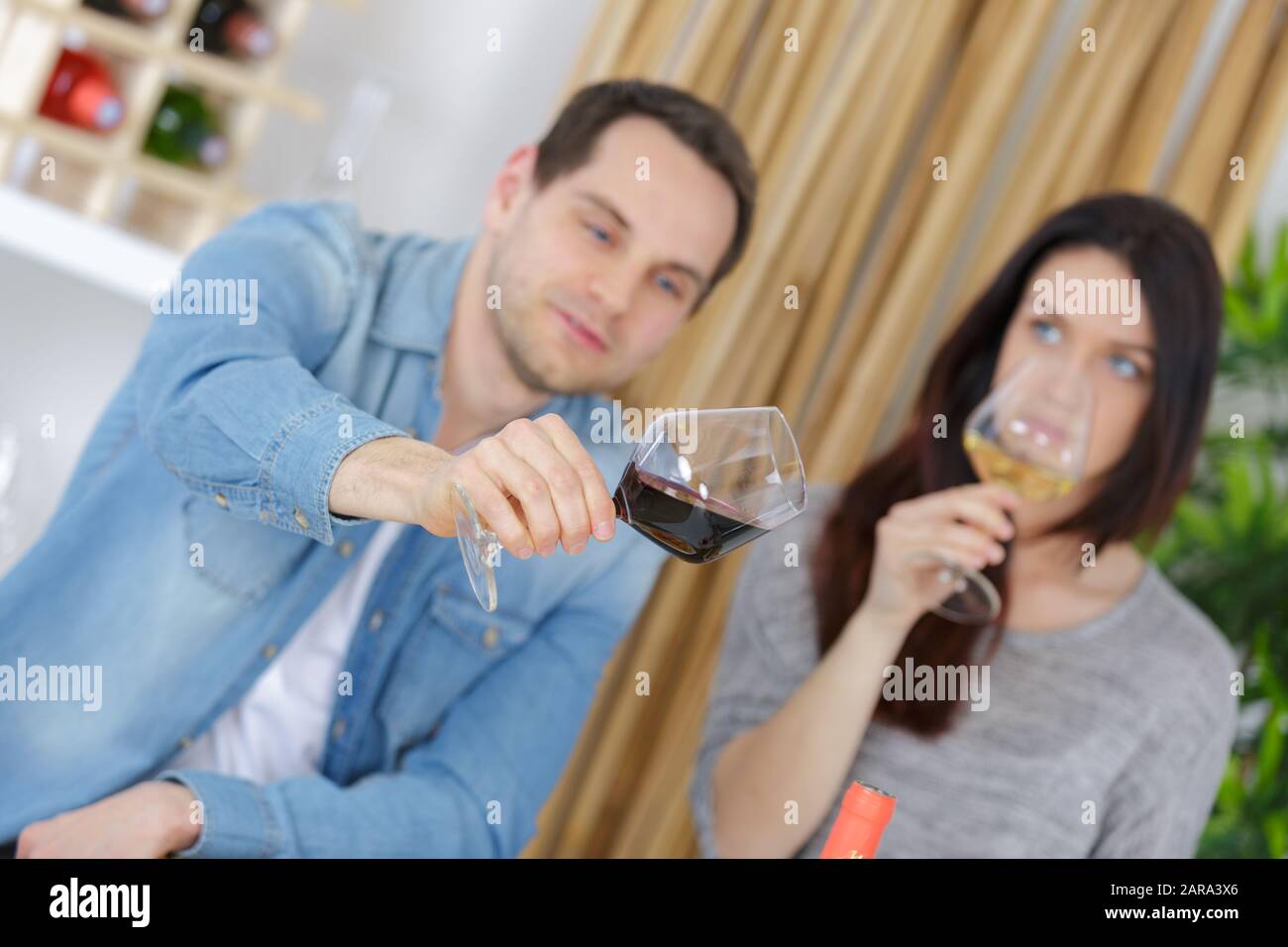 wine loving couple tasting wines in winery Stock Photo - Alamy