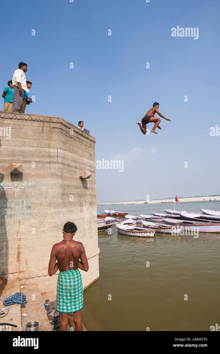 Young boy diving to Ganges river at holy ghats, also Ganga river 