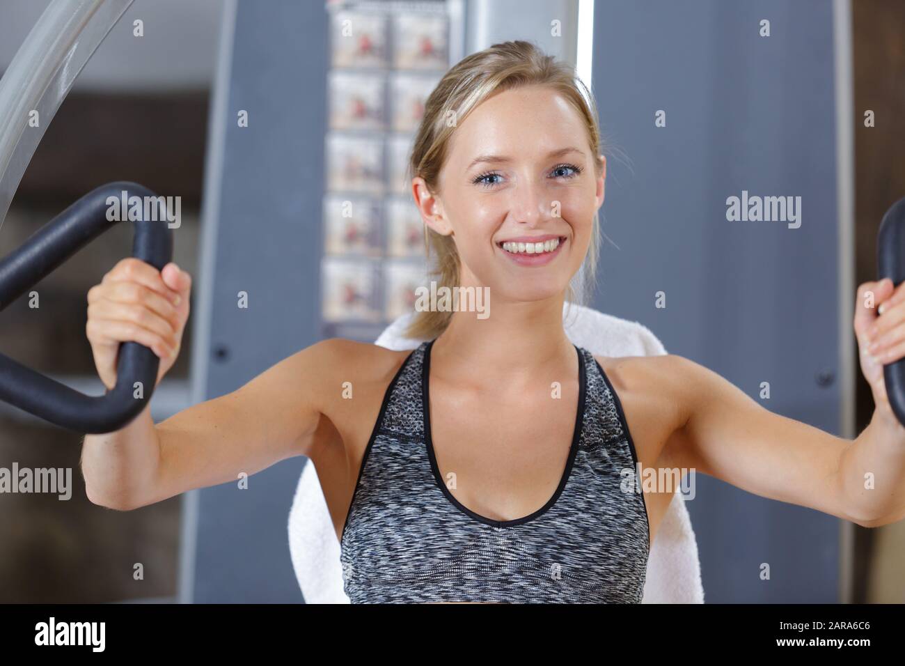 woman doing the butterfly exercise in the gym Stock Photo Alamy