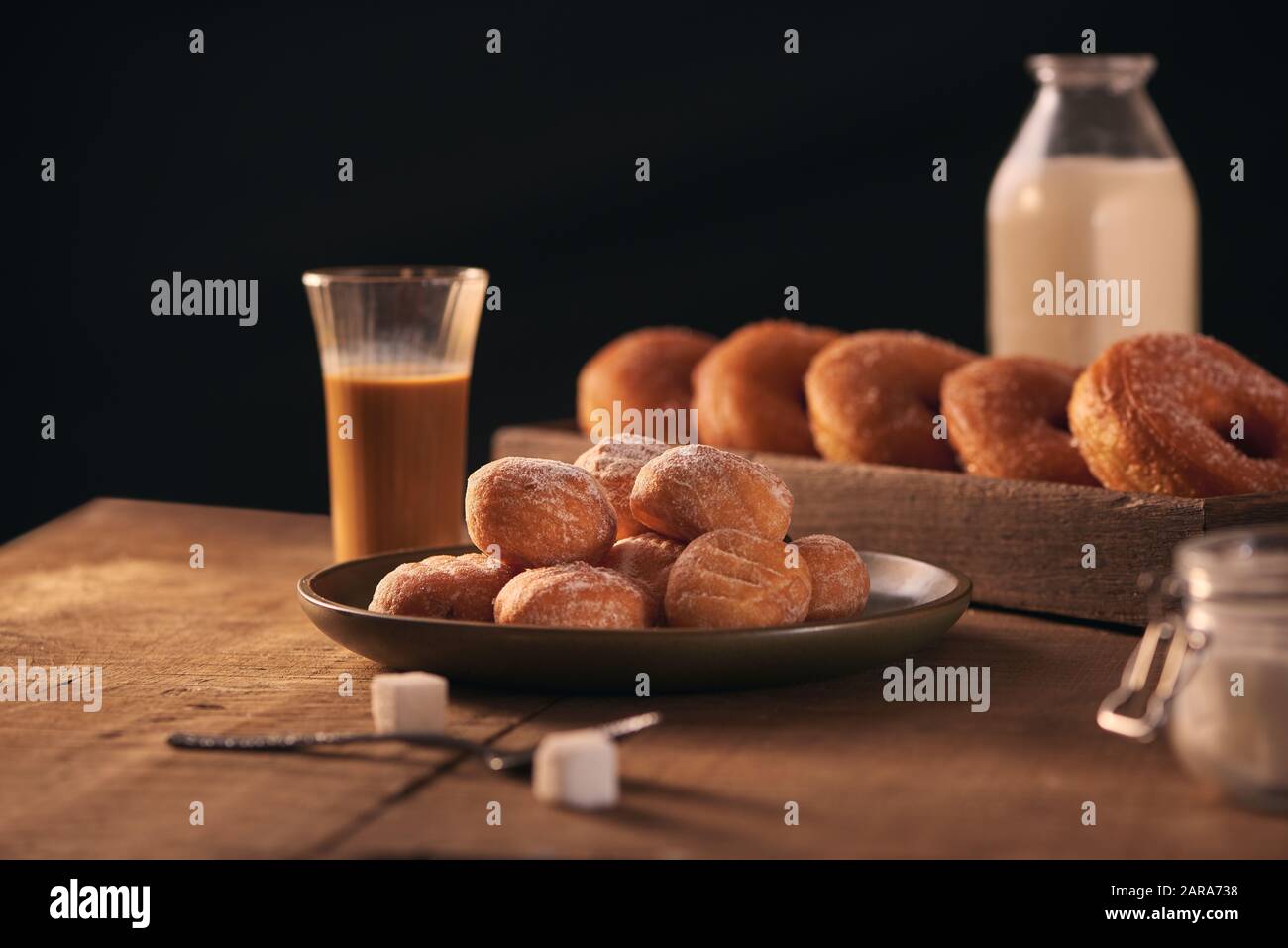 Small balls of freshly baked homemade cottage cheese doughnuts in a plate on a gray background. Stock Photo