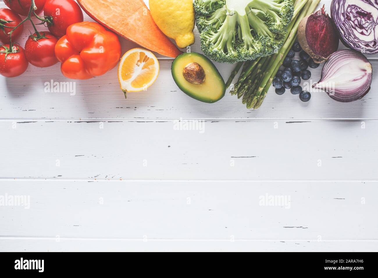 Rainbow colors vegetables and berry background. Detox, vegan food, ingredients for juice and salad. Stock Photo