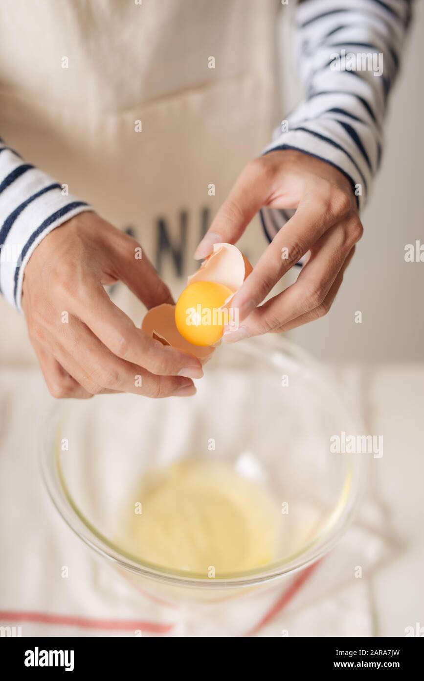 Broken egg in hands hi-res stock photography and images - Alamy