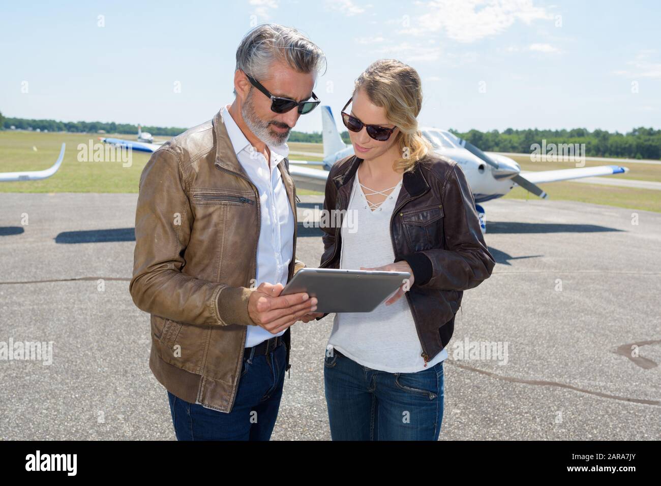 couple looking at tablet before flying Stock Photo