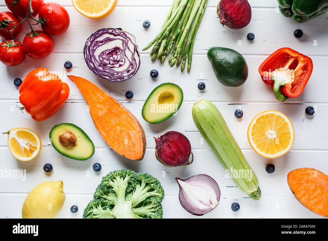 Rainbow colors vegetables and berry background. Detox, vegan food, ingredients for juice and salad. Stock Photo