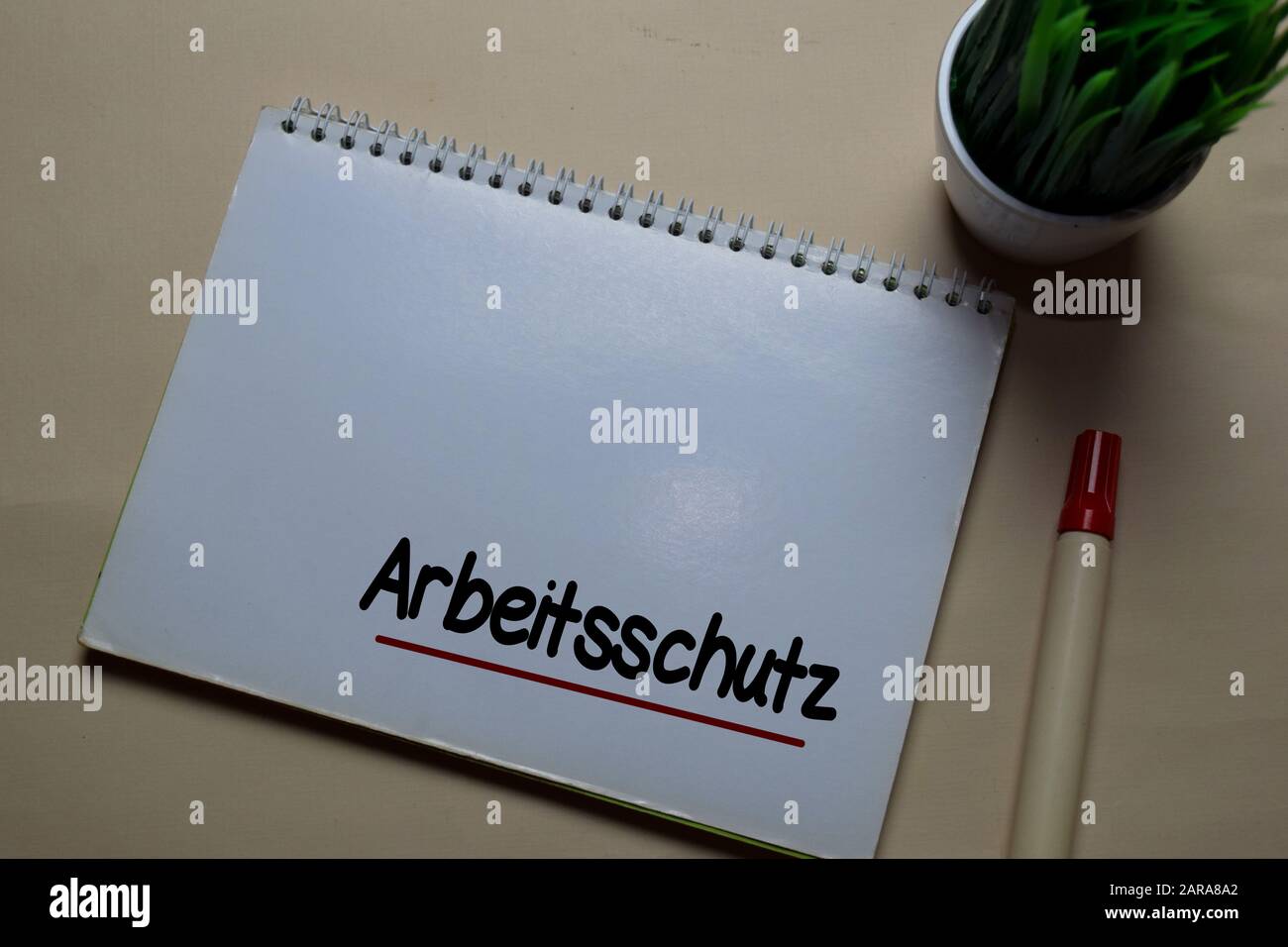 Arbeitsschutz write on a book isolated on office desk. German Language