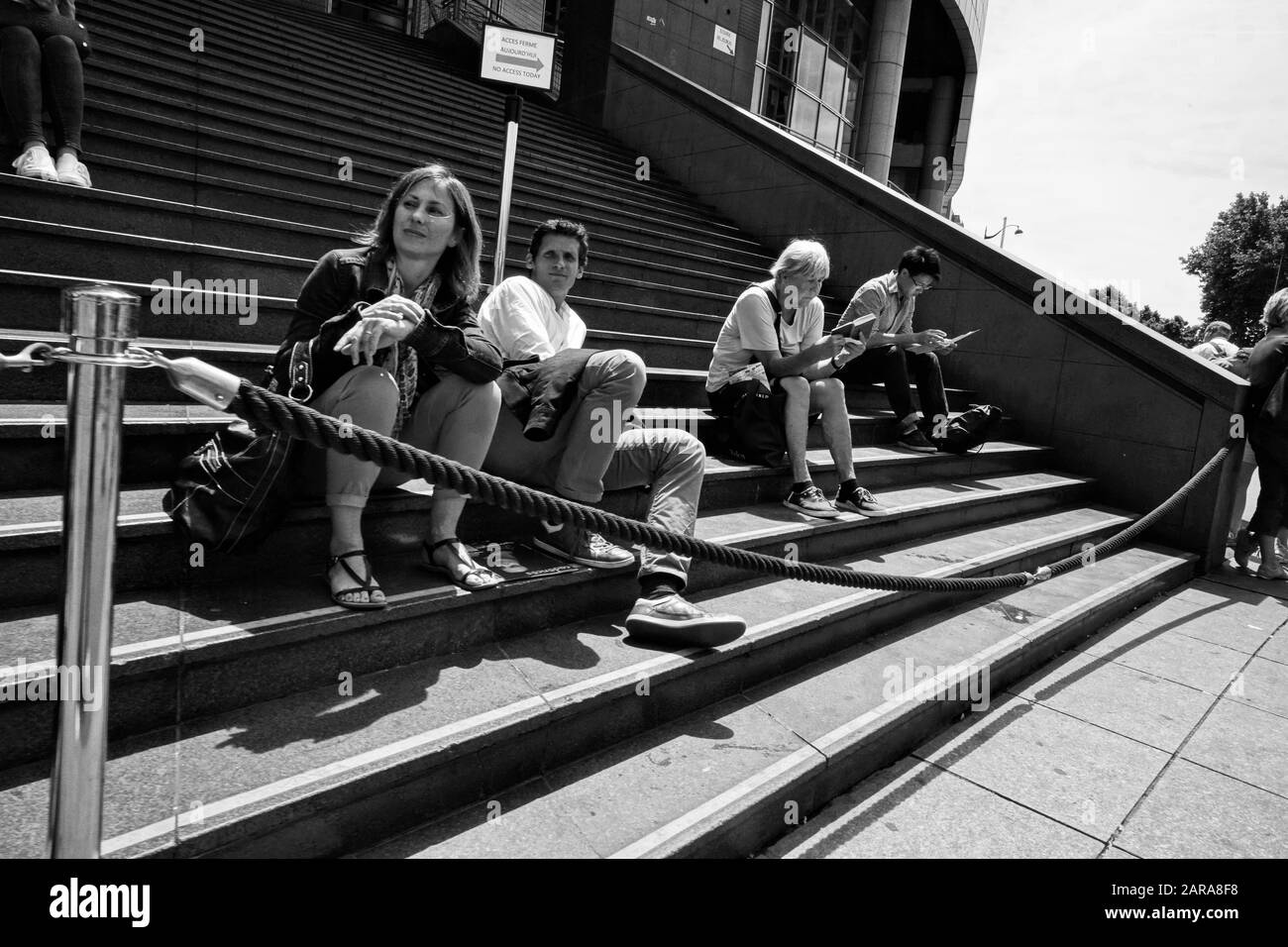 Tourist sitting on steps, Paris, France, Europe Stock Photo