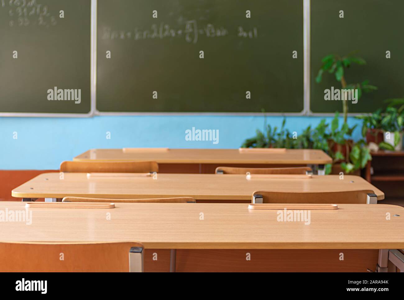 School empty classroom with school desks and blackboard in school. Back to school. Education concept. Stock Photo