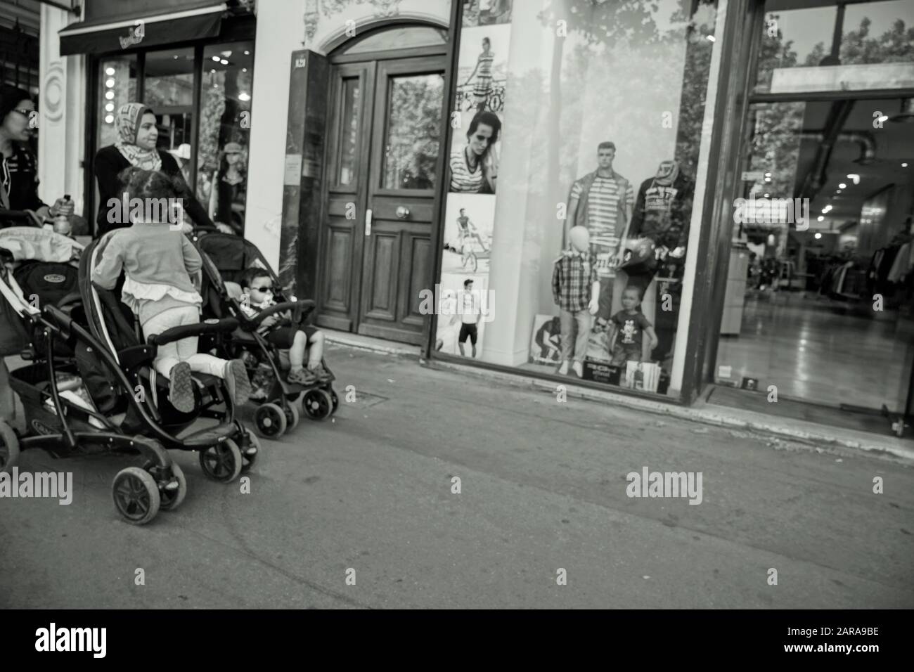 Kids in prams, Fashion garments shop window, Paris, France, Europe Stock Photo