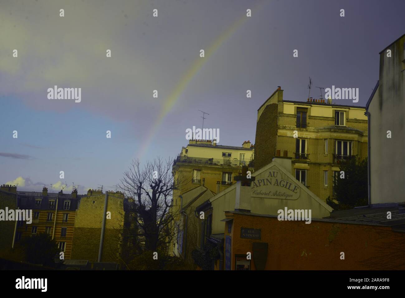 Paris: a rainbow over the infamous ‘Lapin Agile’ cabaret, by pasakdek Stock Photo