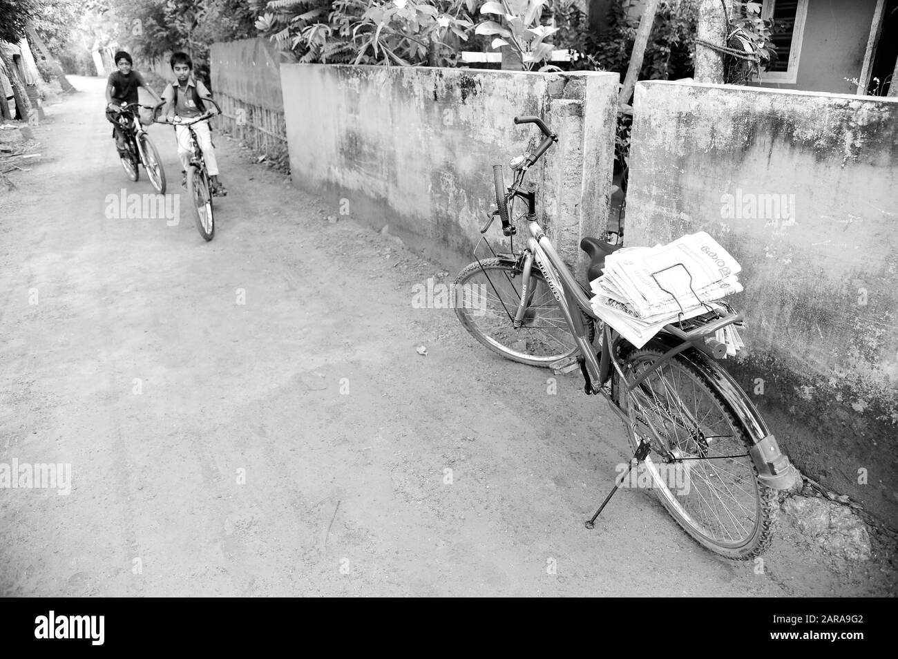 Newspaper distribution on bicycle, Coconut Lagoon Resort, Kumarakom, Kottayam, Kerala, India, Asia Stock Photo
