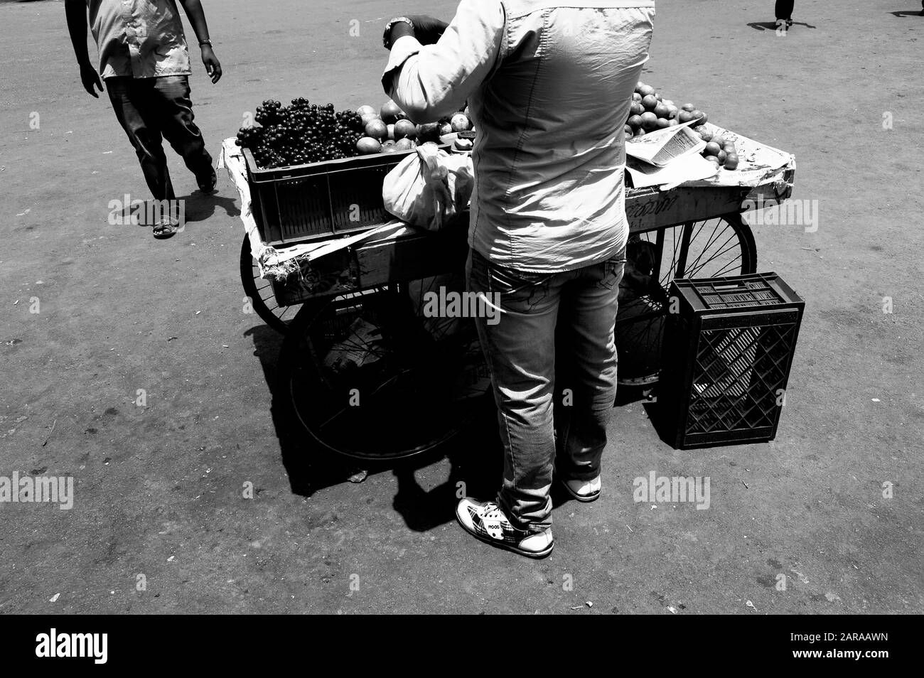Indian man selling fruit Black and White Stock Photos & Images - Alamy