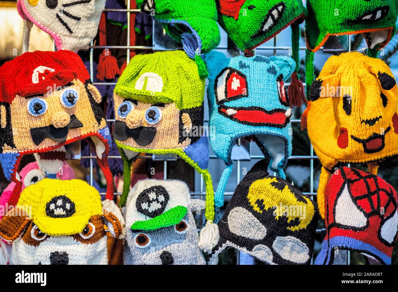 London, UK - November 27, 2019 - Crochet knitted hats in different cartoon characters on display at Christmas market in Winter Wonderland Stock Photo