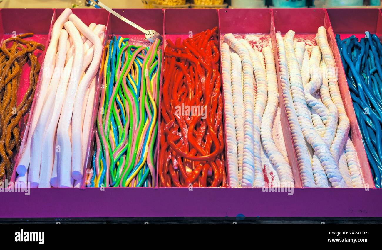 Assorted soft sugar cable sweets on display at the Christmas market in winter wonderland of London Stock Photo