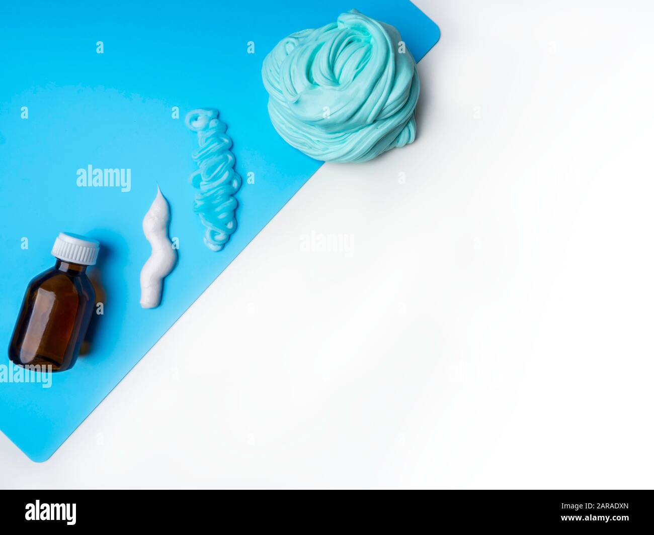 Components to make slime. Child education concept. On blue surface ...
