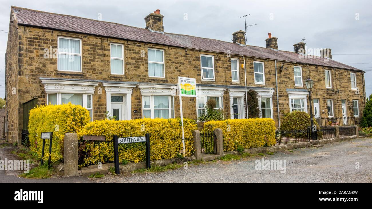A complete terrace of traditional build, period houses in the market town of Leyburn, Richmondshire, North Yorkshire, England, UK. Stock Photo