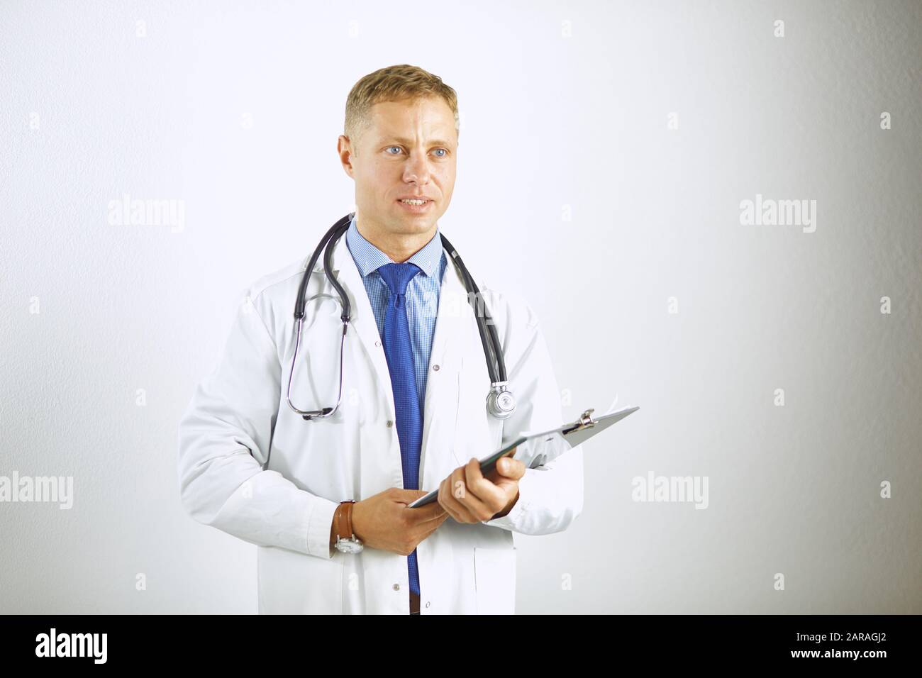 Young confident doctor in a white coat with a stethoscope Stock Photo ...