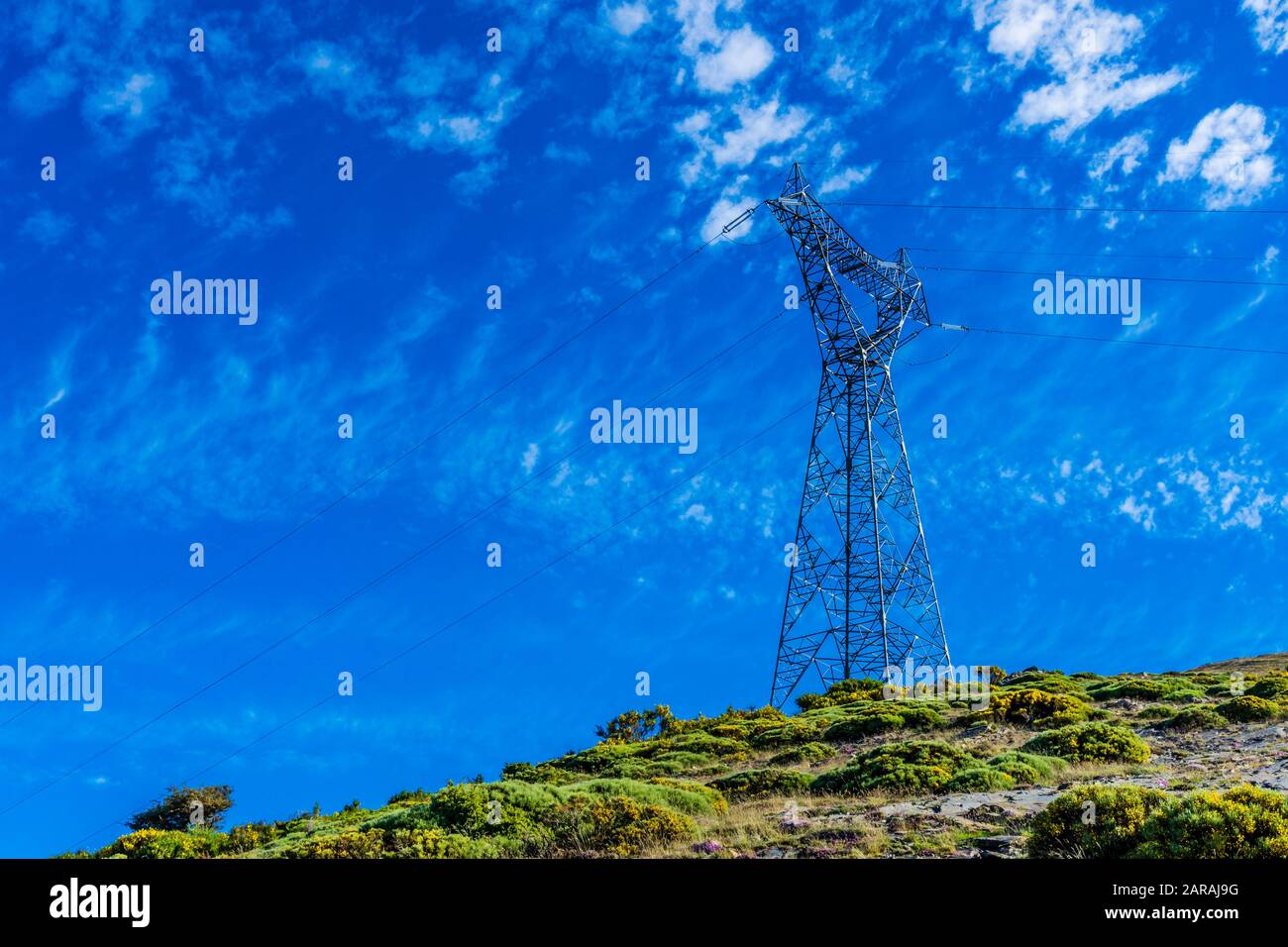 High-voltage tower on a blue sky background Stock Photo - Alamy