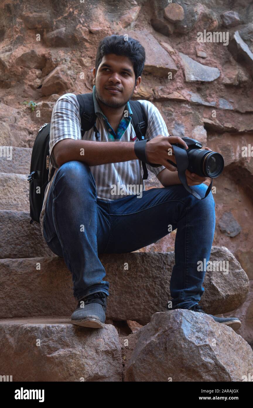 Stylish indian young man photographer at sunglasses wear casual posed  outdoor against iron stairs with dslr photo camera at hands. 10488429 Stock  Photo at Vecteezy