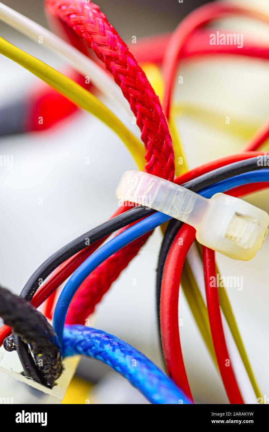 Multicolored electrical cables isolated close up. Vertical image. Selective focus. Stock Photo