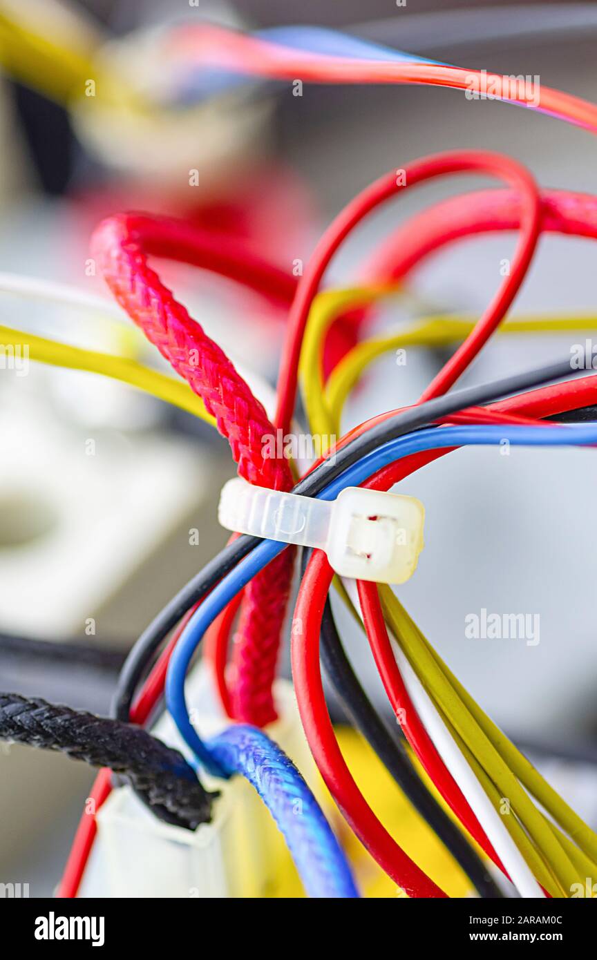 Multicolored electrical cables isolated close up. Vertical image. Selective focus. Stock Photo