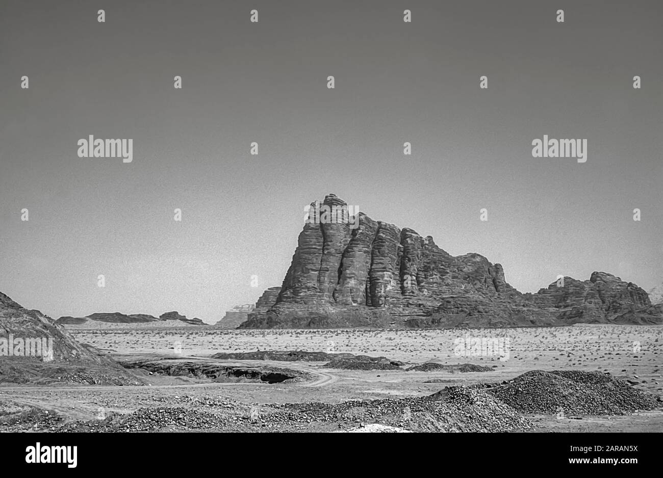 Jordan. Monochrome scenes at the UNESCO World Heritage Site of Wadi Rum near the port of Aqaba in southern Jordan  looking towards the Seven Pillars of Wisdom mountain associated with Lawrence of Arabia. Stock Photo