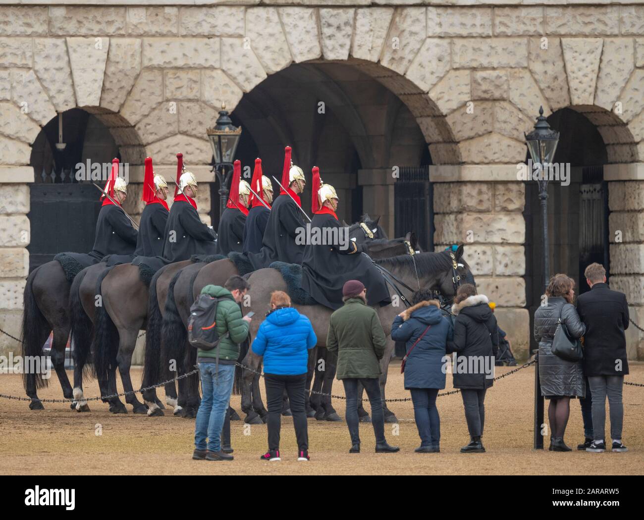 London, UK. Mounted troops of the Blues and Royals take part in Changing the Guard at Horse Guards Parade, watched by tourists. Stock Photo
