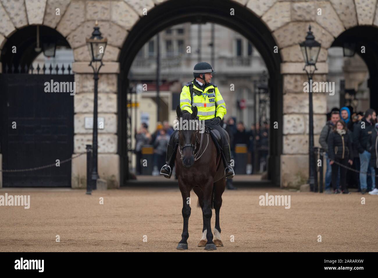 Metropolitan Police mounted officer on duty in front of the archway at Horse Guards Parade during The King’s March event, January 2020, London UK. Stock Photo