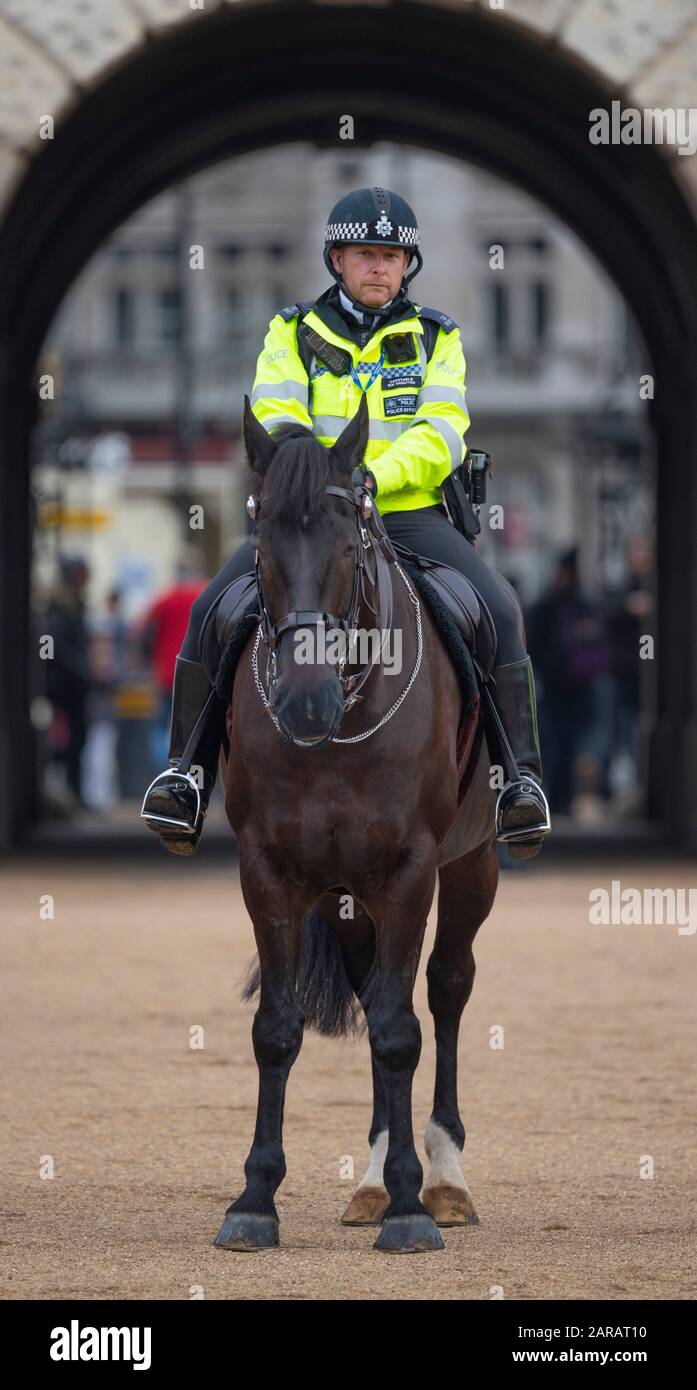 Metropolitan Police mounted officer on duty in front of the archway at Horse Guards Parade during The King’s March event, January 2020, London UK. Stock Photo