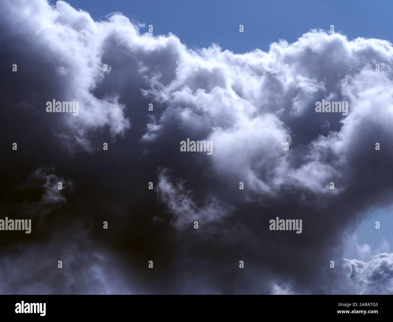 Dark clouds against a bright blue sky Stock Photo