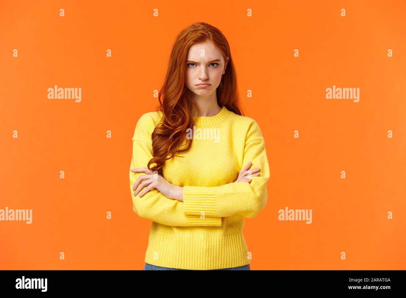 I am mad. Offended sulky cute and timid redhead curly girl, cross arms chest, sulking angry and tensed, frowning stare disappointed someone sad rude Stock Photo