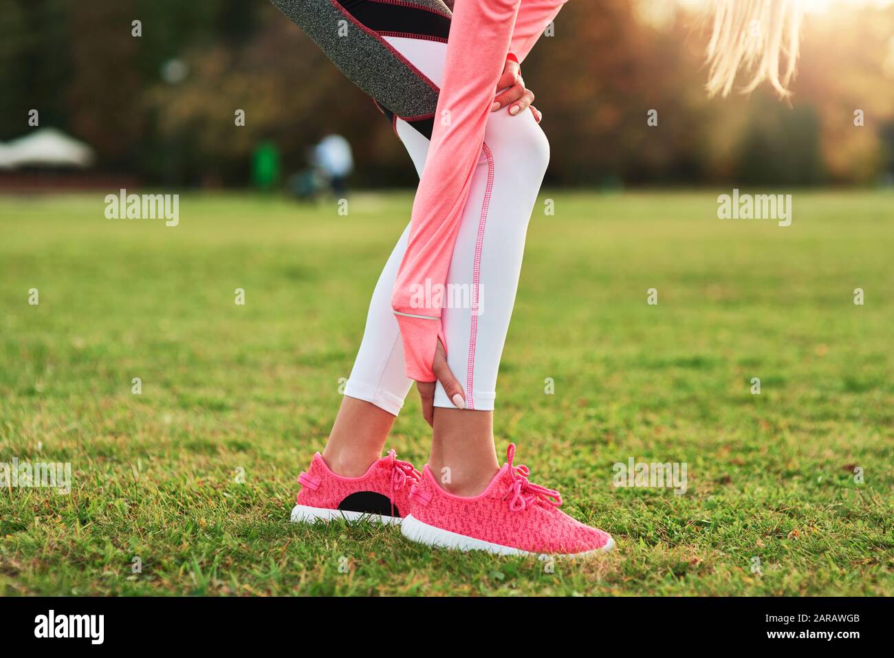 Close up of sporty woman suffering from calf pain Stock Photo