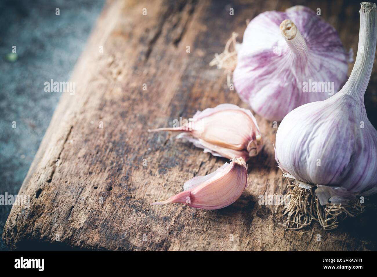 Organic garlic bulbs with garlic cloves on old wooden board Stock Photo ...