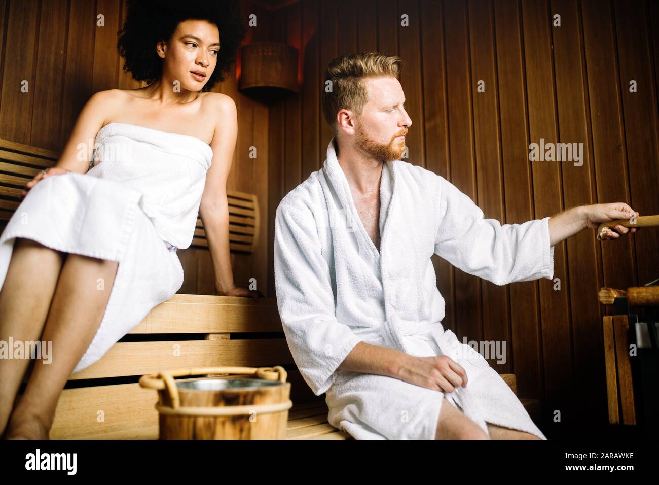 Couple enjoying finnish sauna during their spa weekend Stock Photo