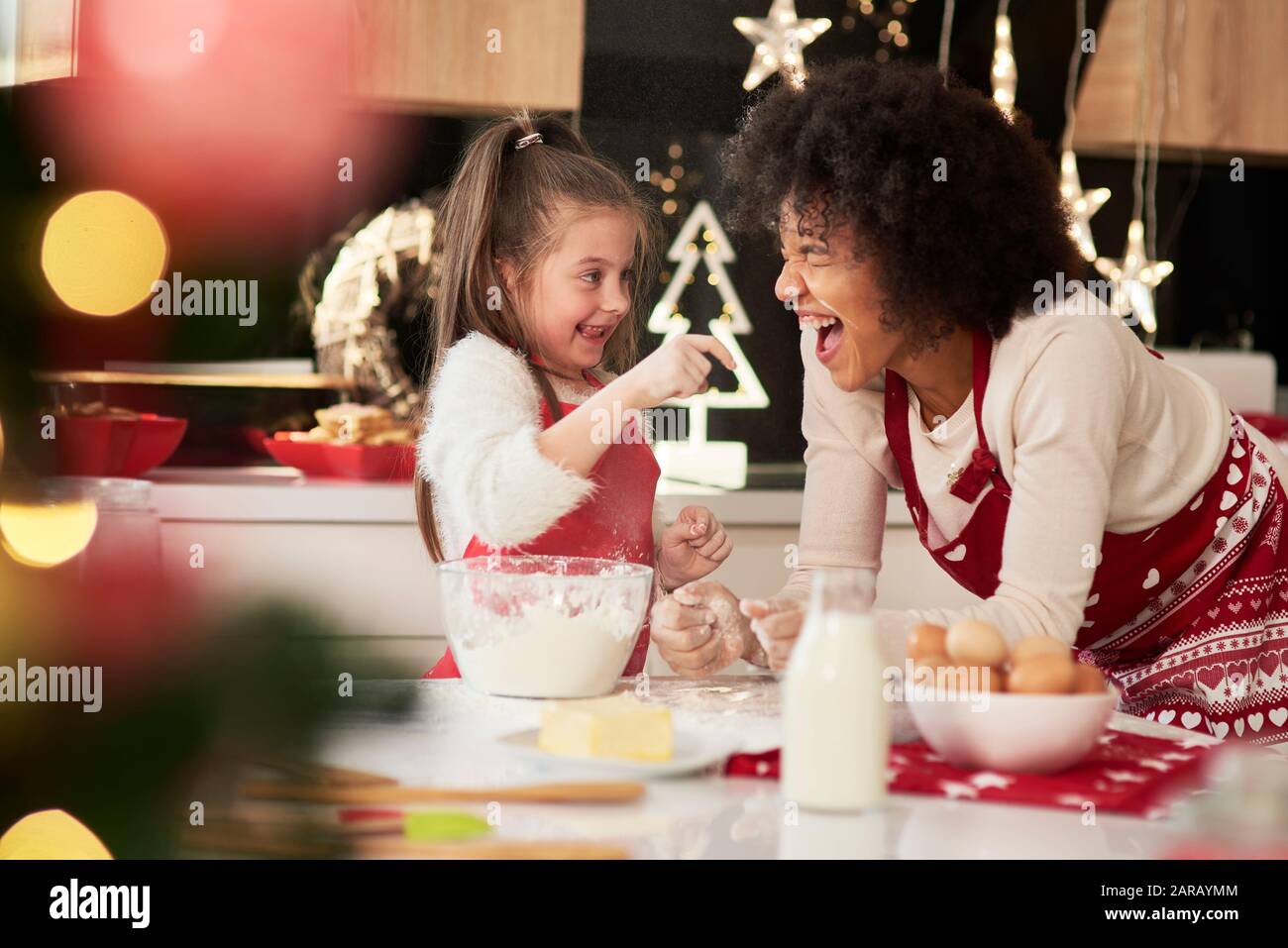 Mother and daughter enjoying in the kitchen at Christmas Stock Photo