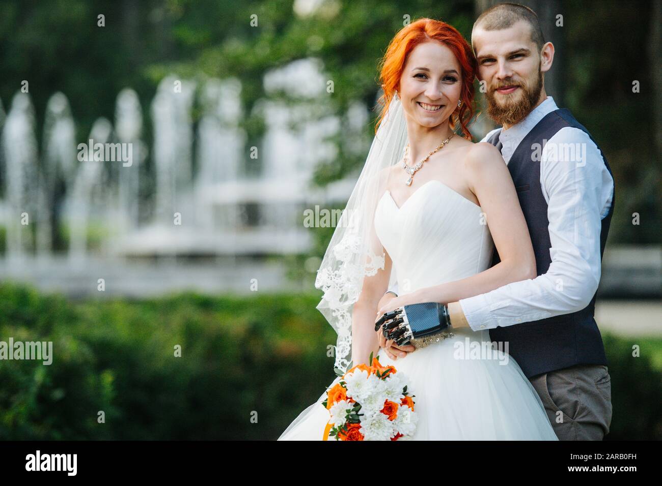Portrait of the newly wed couple standing together in the park Stock Photo