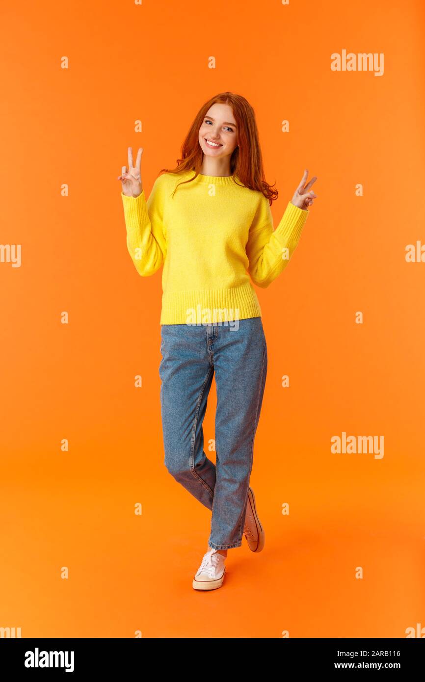 Vertical full-length cute lovely redhead teenage girl in jeans and ...